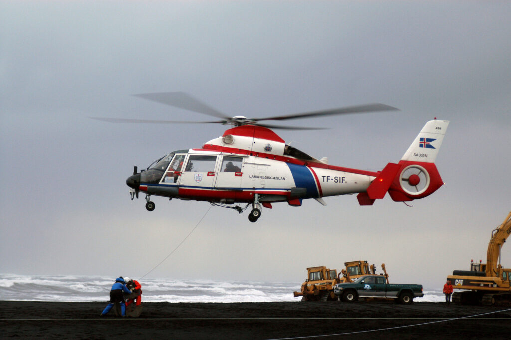 Dark-green Aérospatiale Dauphin 2 helicopter on a snowy plateau