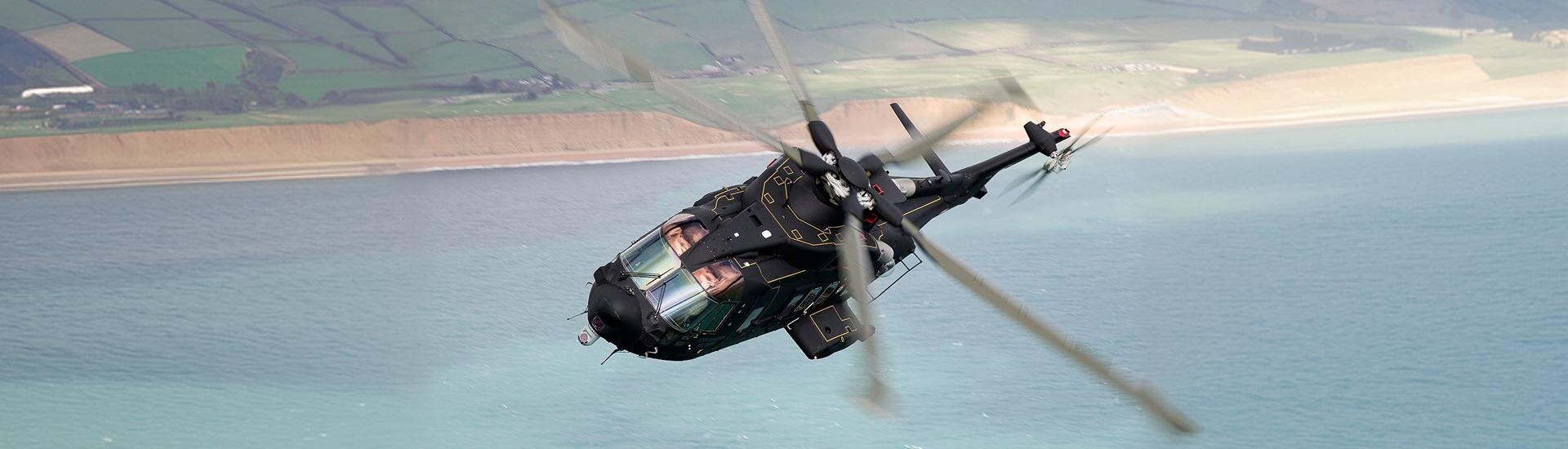 AgustaWestland AW101 helicopter flying low over a moor at dusk