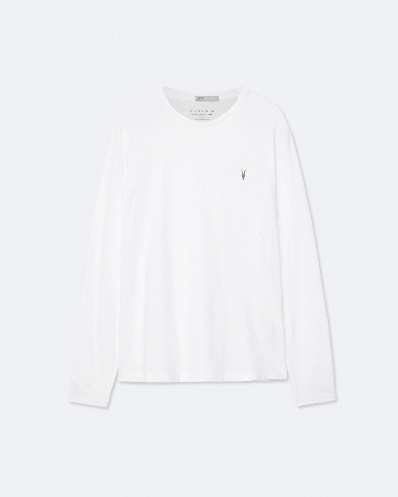 White long-sleeve undershirt folded beside a grey wool sweater