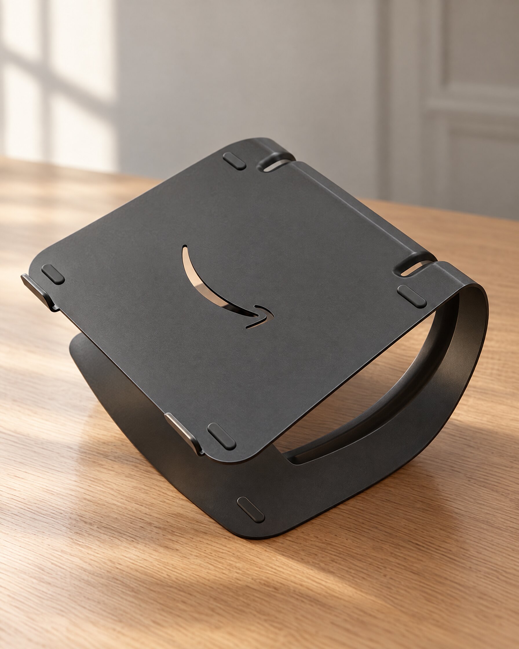 Black Amazon Basics laptop stand on an oak desk in soft natural light