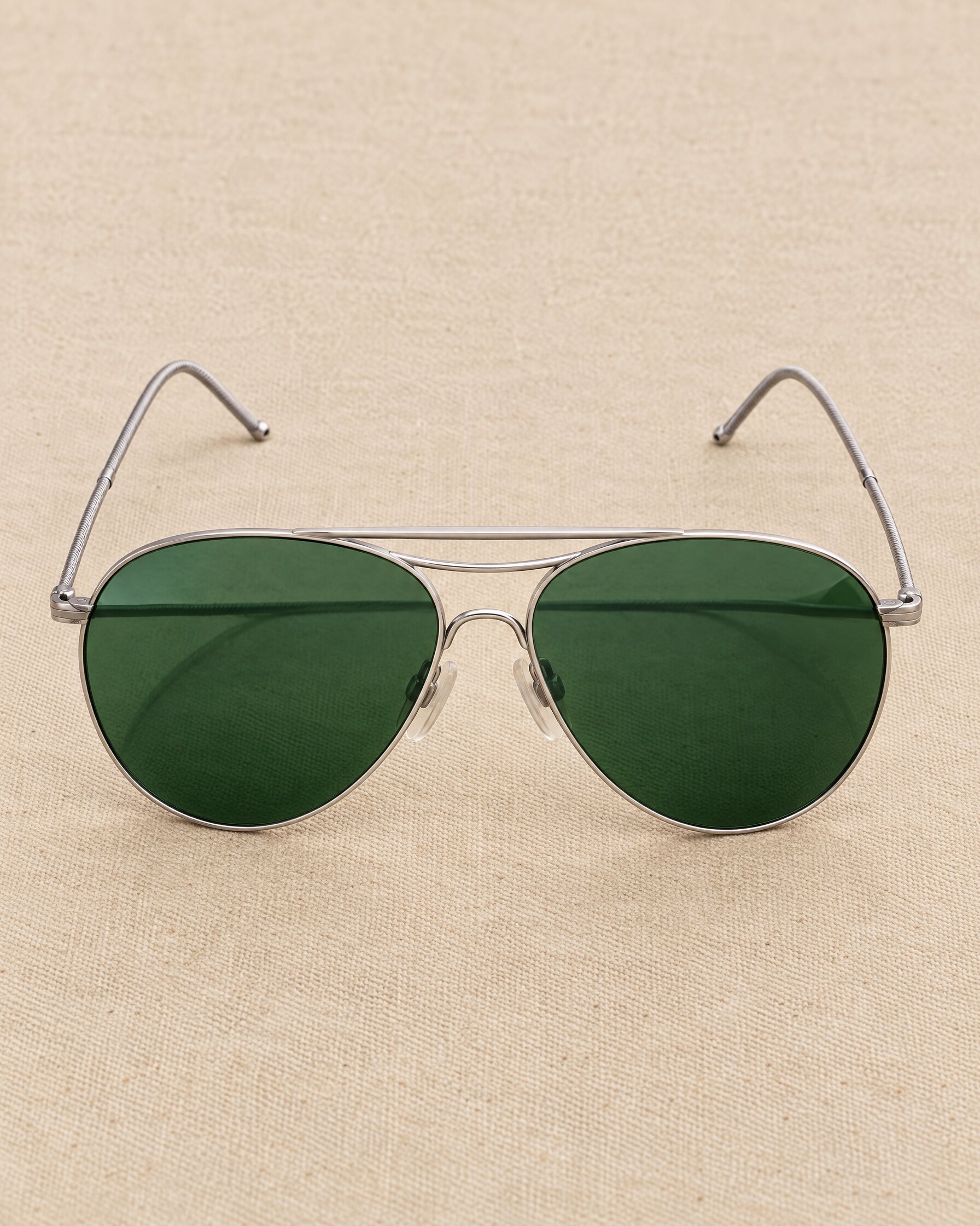 Vintage American Optical AN-6531 style aviator sunglasses with green lenses on canvas