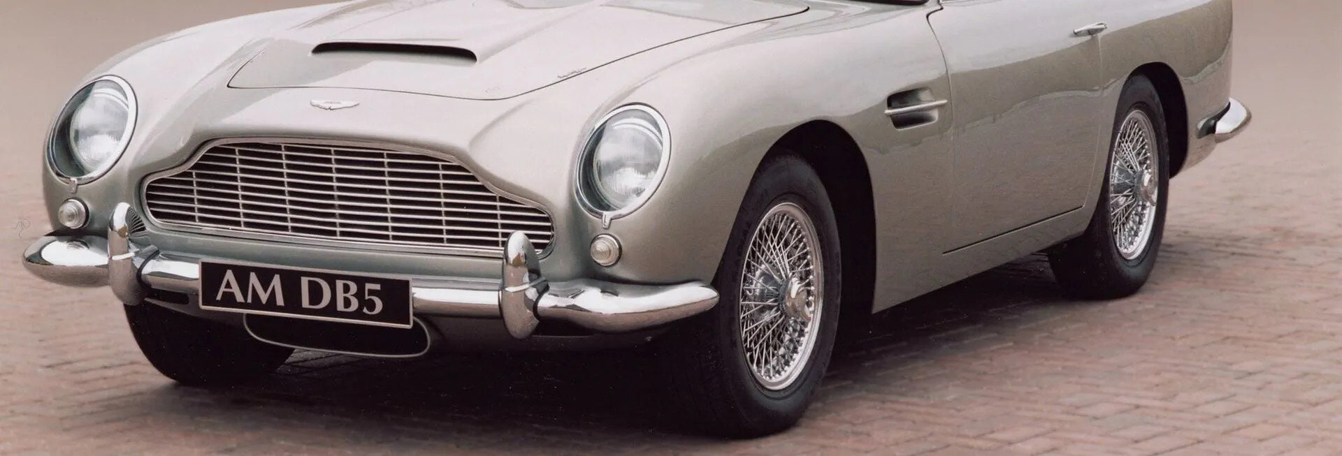 Aston Martin DB5 silver front wing and headlamp in evening light