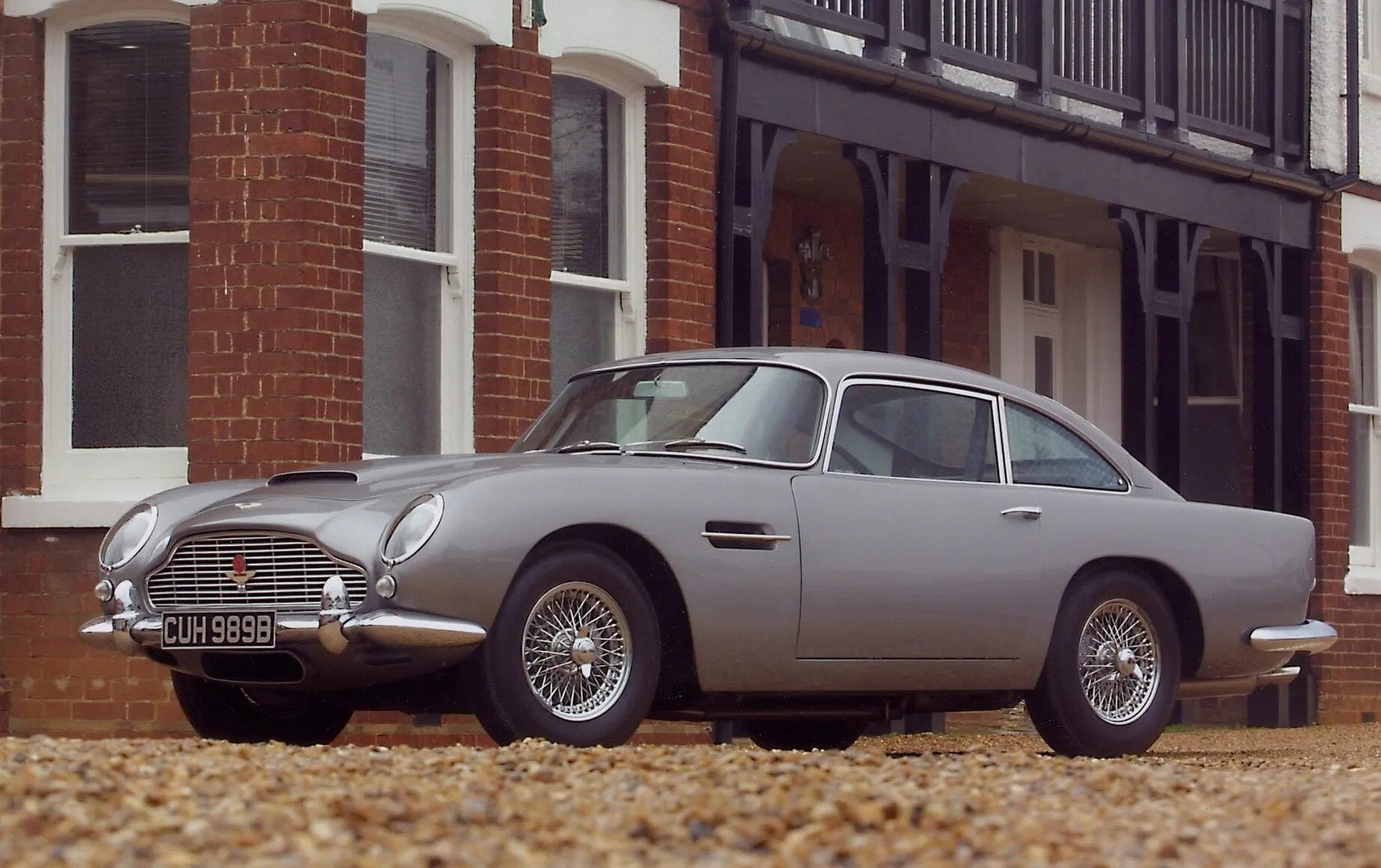 Aston Martin DB5 silver front wing and headlamp in evening light