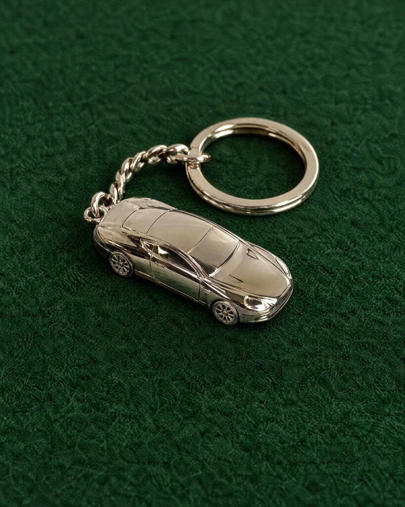 Aston Martin DB9 keyring in solid silver on green baize