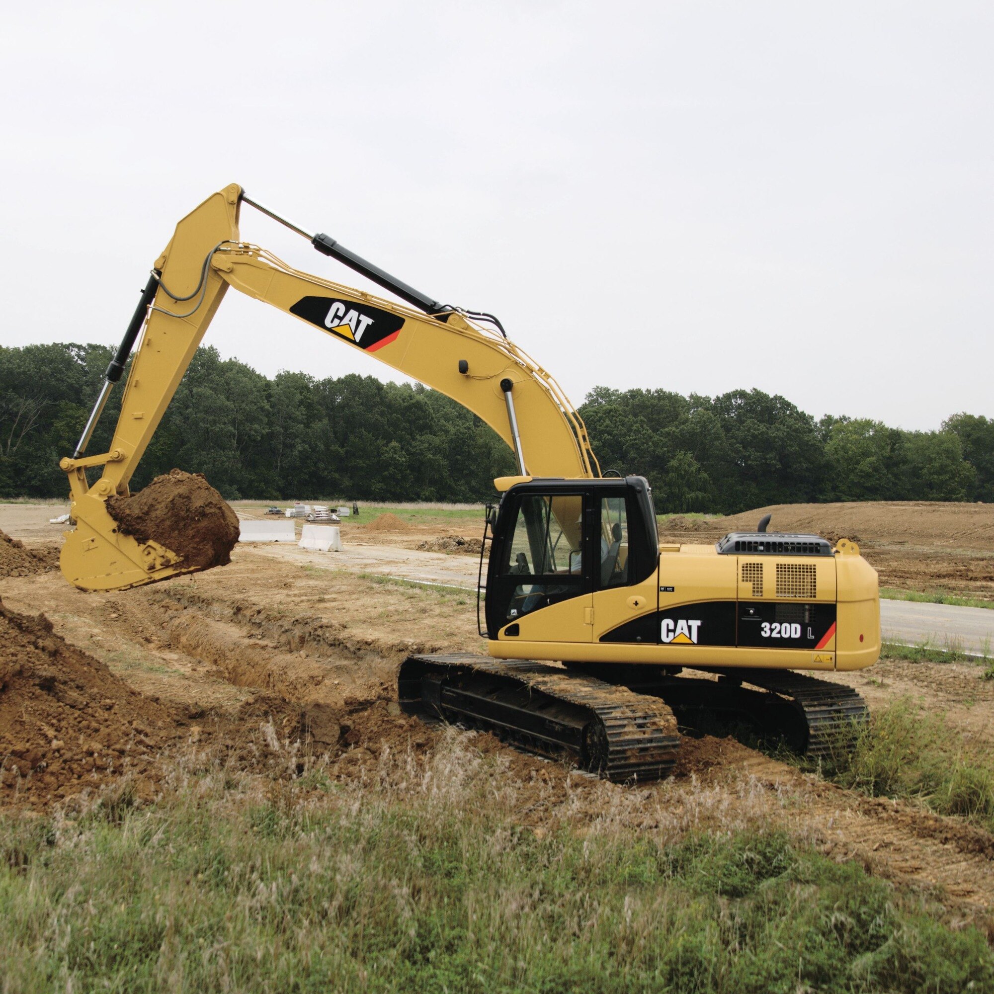 Yellow excavator arm and bucket at golden hour, like the Caterpillar 320D L