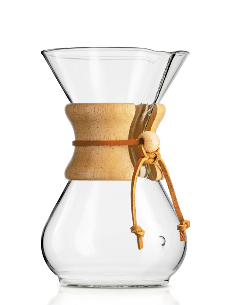 Glass Chemex coffeemaker with wood collar on a marble counter