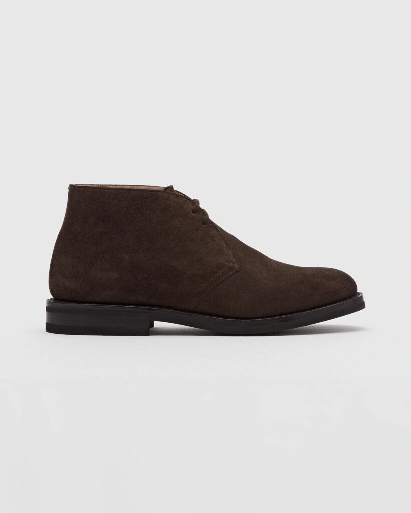Church's brown suede chukka boots flat lay with folded shirt and leather belt