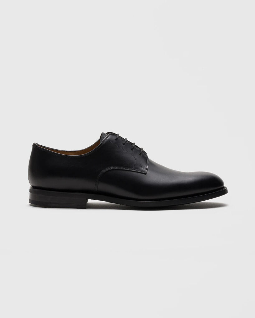 Church's Cartmel style black calf derby shoes with almond toe on a stone surface