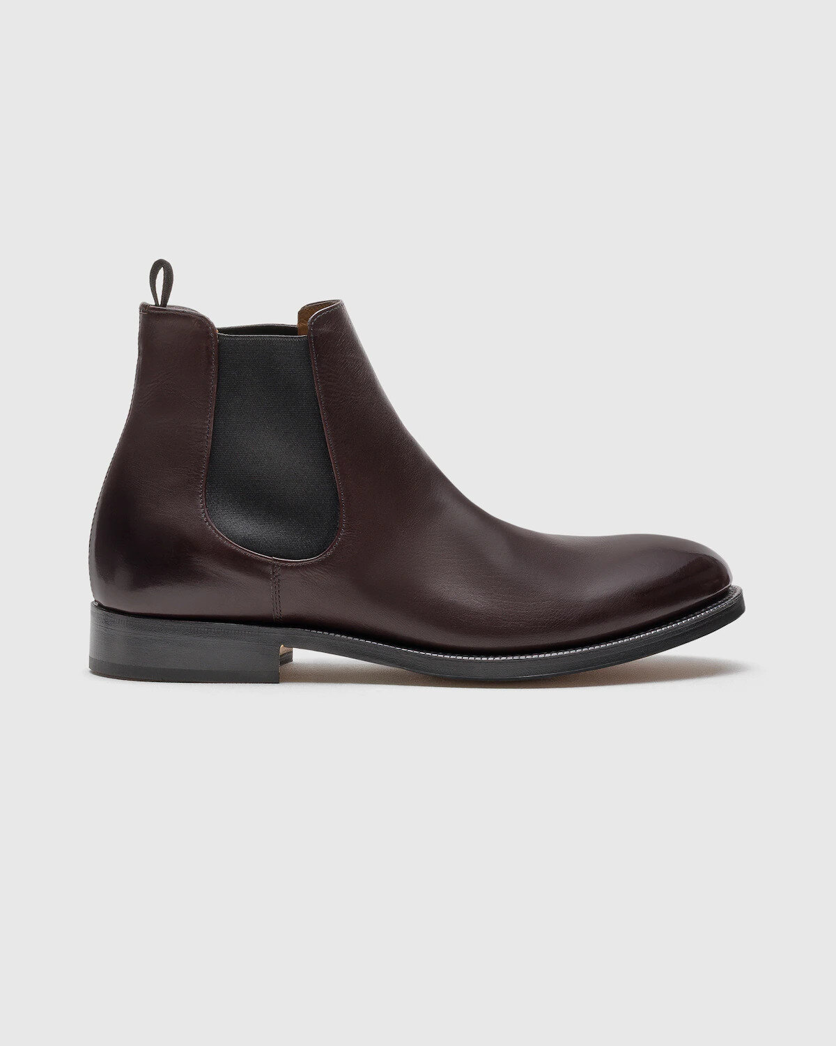 Pair of light brown single monk strap shoes on a limestone step