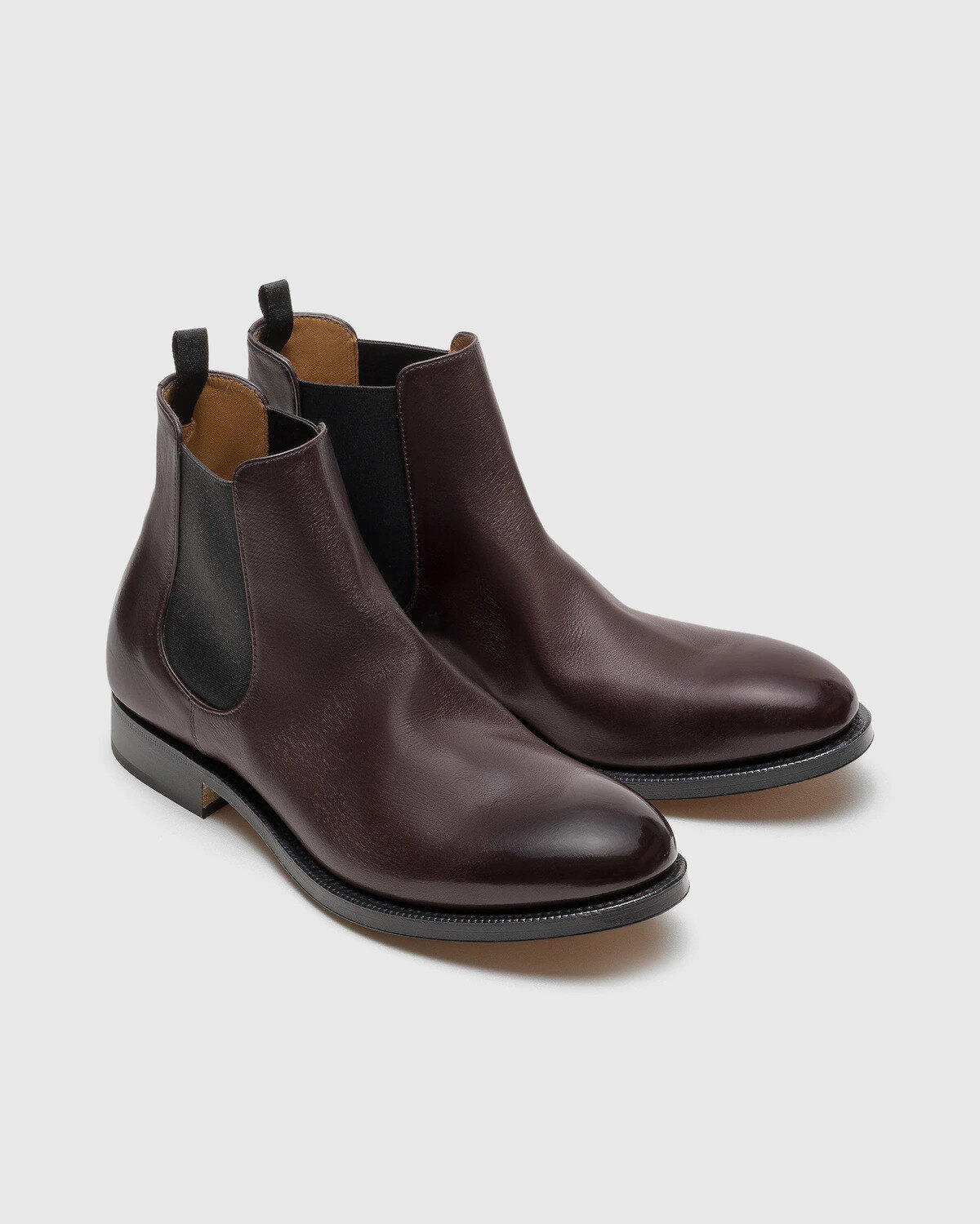 Pair of light brown single monk strap shoes on a limestone step