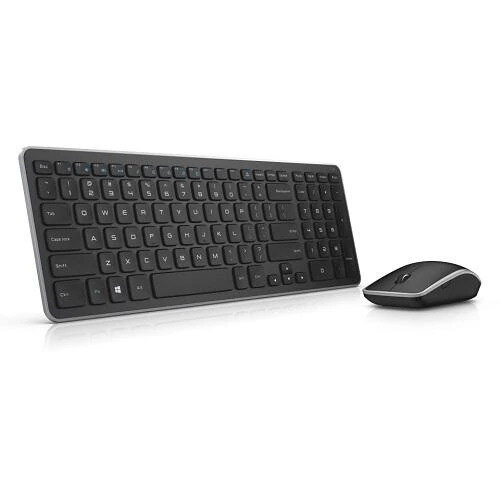 Low side-on detail of a slim black Dell KM714 wireless keyboard on a walnut desk in soft natural light