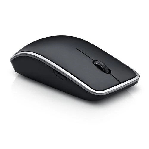 Dell WM514 wireless mouse on a walnut desk in soft natural light