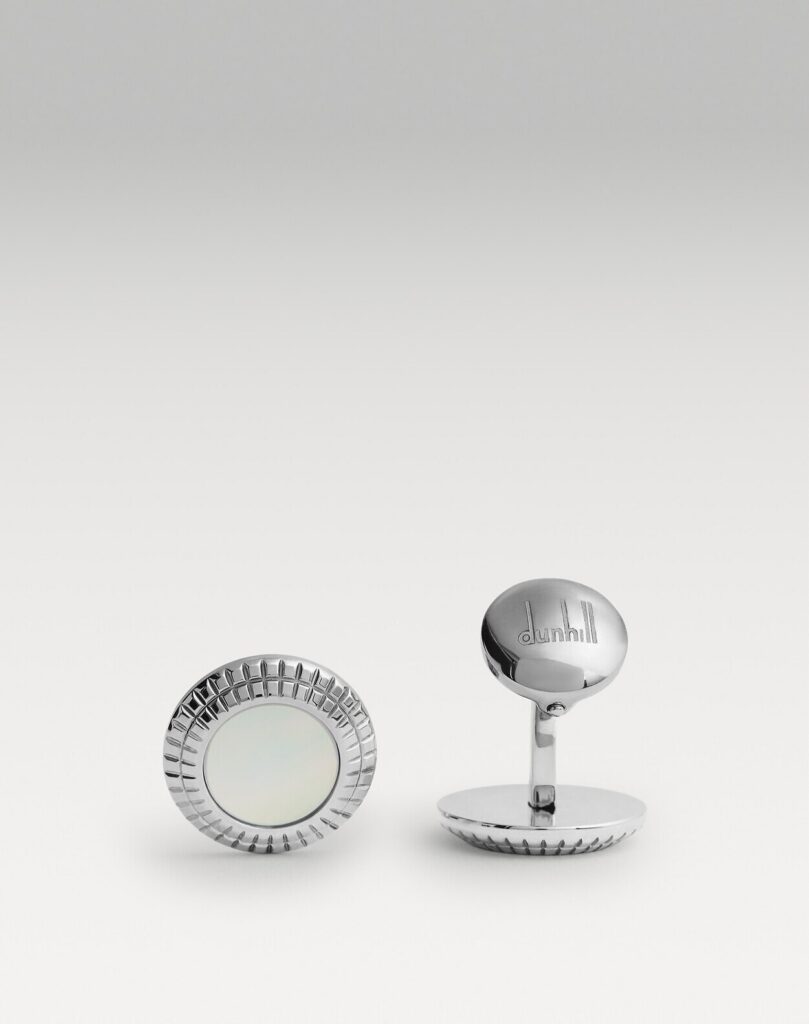 Dunhill style L-shaped metal cufflinks on a white double cuff