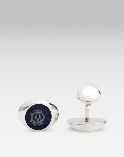 Dunhill gold cufflinks in close detail on a white double cuff