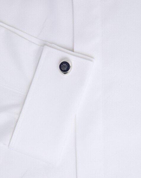 Dunhill gold cufflinks in close detail on a white double cuff