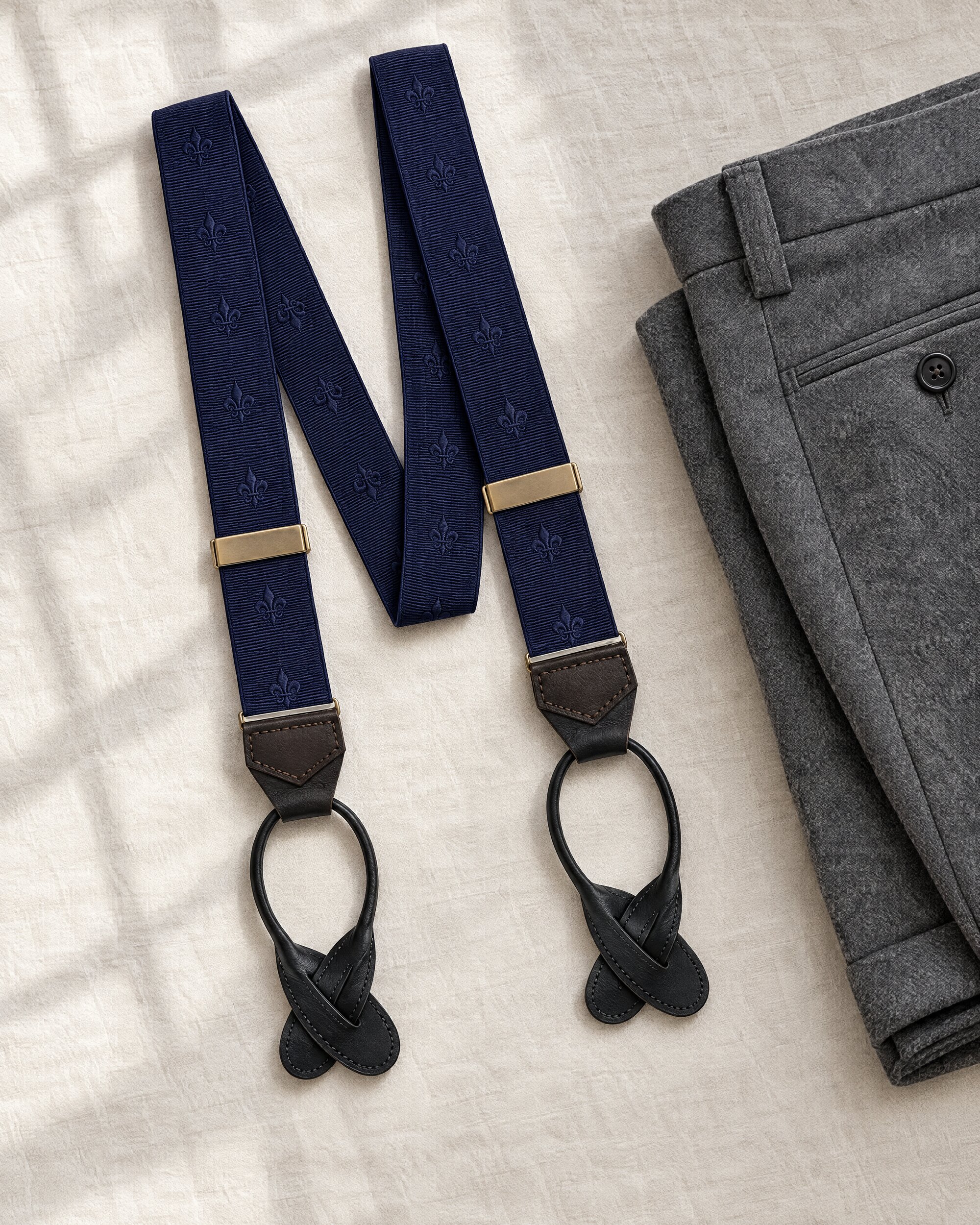 Ede & Ravenscroft Fleur De Lys braces in navy on grey flannel trousers