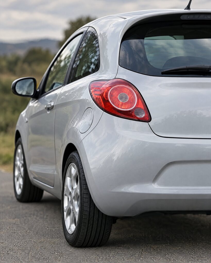 Close detail of the tail lamp and rear bumper of a second-generation Ford Ka hatchback in soft natural light