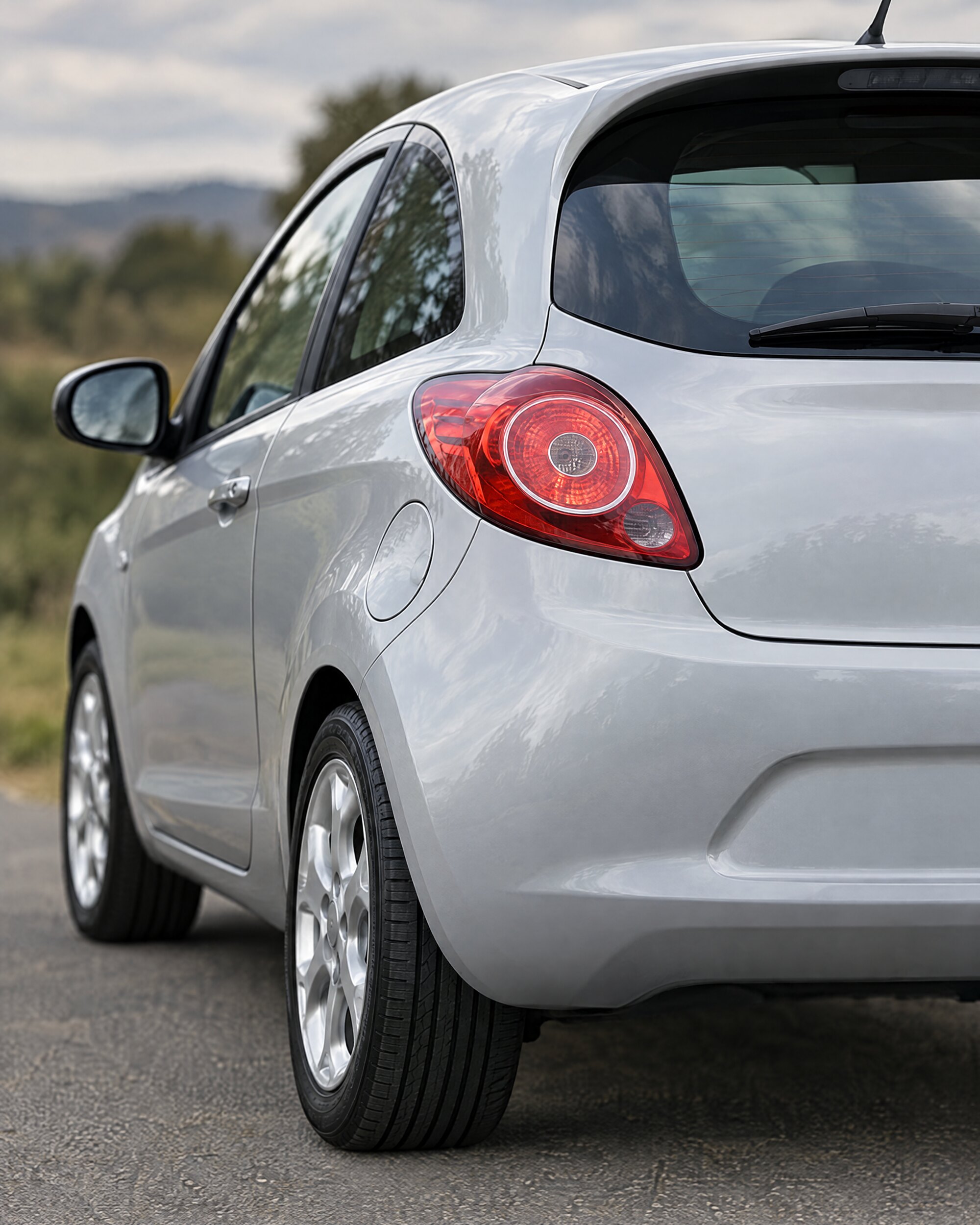 Close detail of the tail lamp and rear bumper of a second-generation Ford Ka hatchback in soft natural light