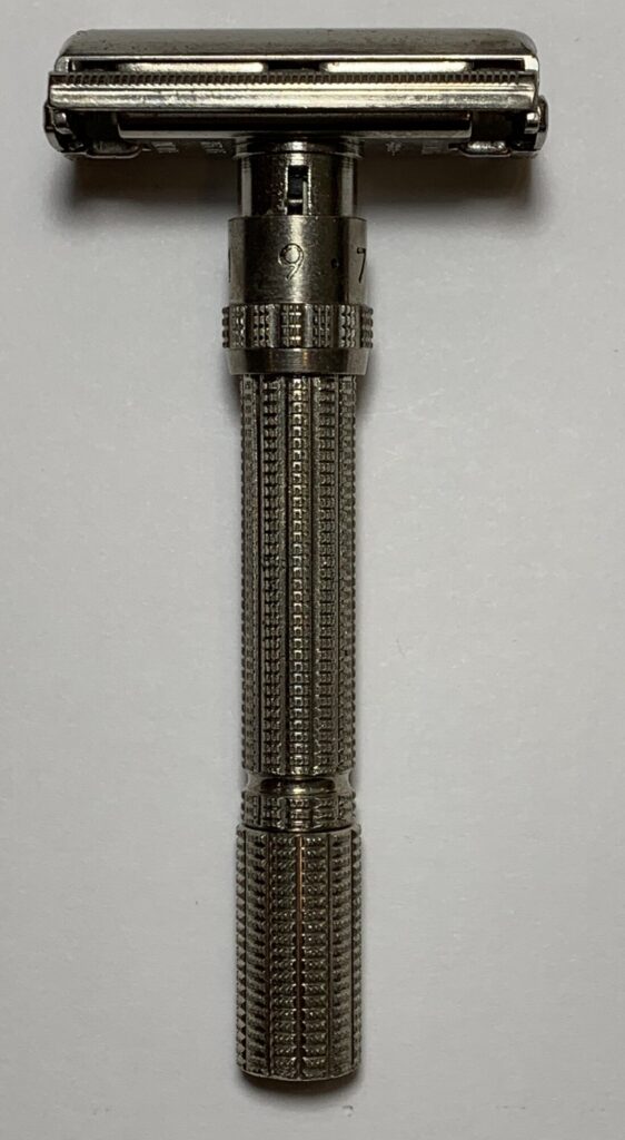 Chrome Gillette Slim Adjustable razor on a white porcelain basin edge