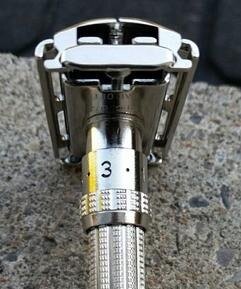 Chrome Gillette Slim Adjustable razor on a white porcelain basin edge