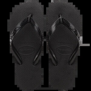 Black rubber flip-flops laid out with a grey towel and navy swim shorts