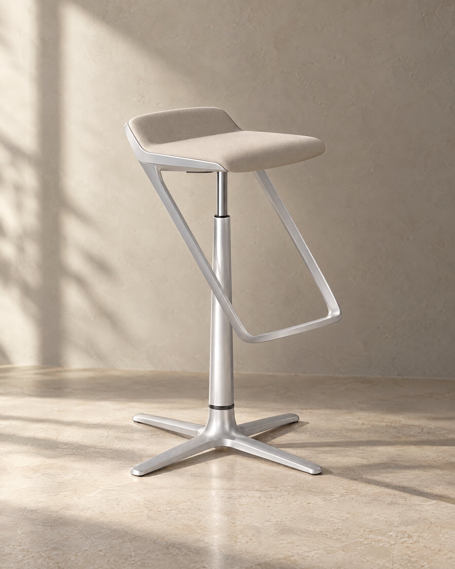Interstuhl KINETICis5 bar stool with aluminium base and pale seat against a grey plaster wall
