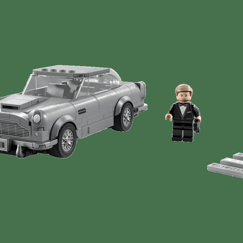 LEGO Speed Champions Aston Martin DB5 in silver-grey, side profile on a pale stone surface