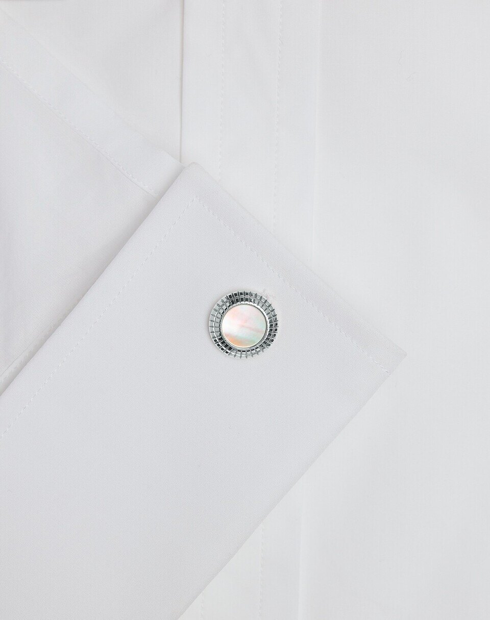 Dunhill mother of pearl cufflinks in close detail on a white double cuff