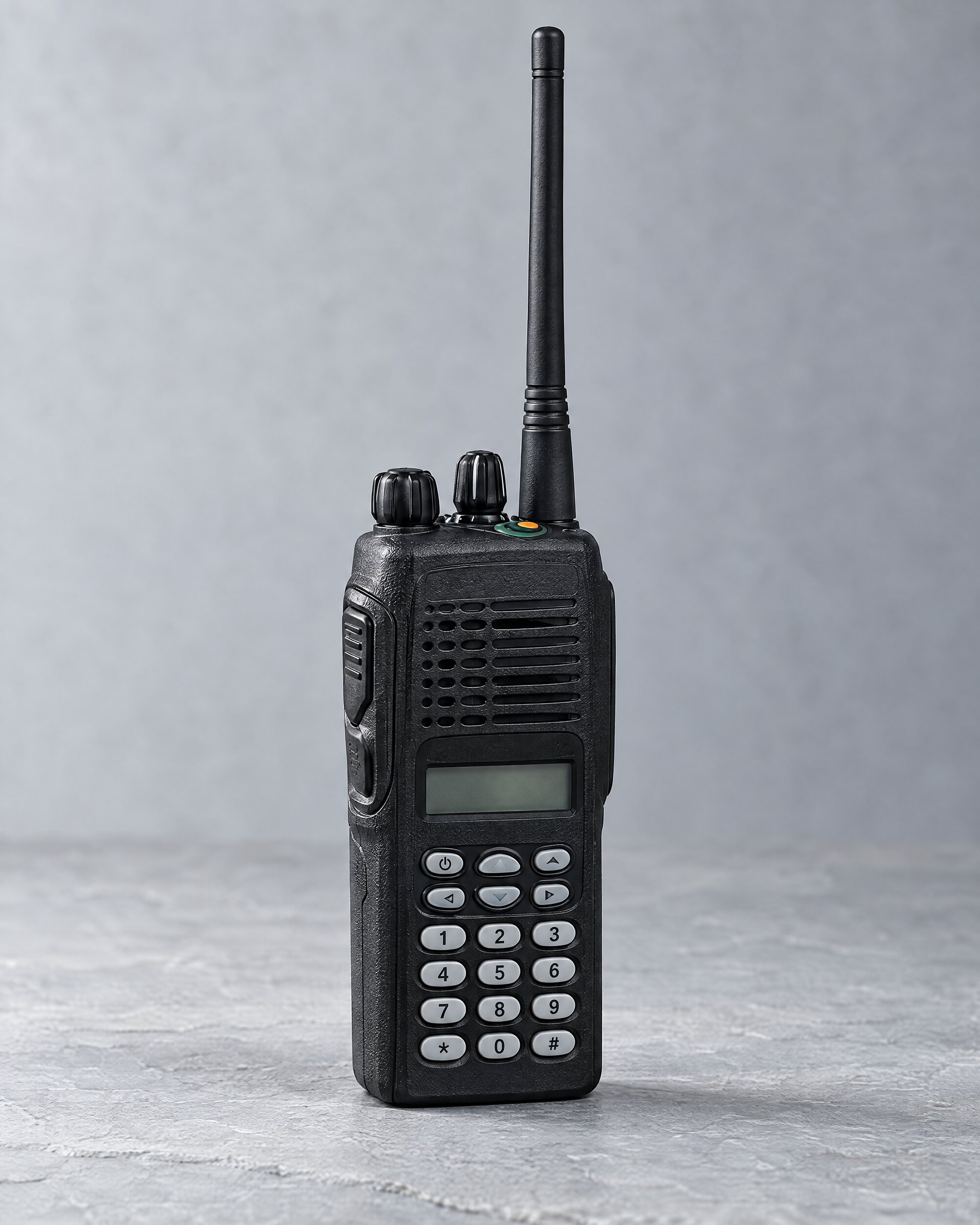 Motorola HT1250 style two-way radio with full keypad on a slate surface