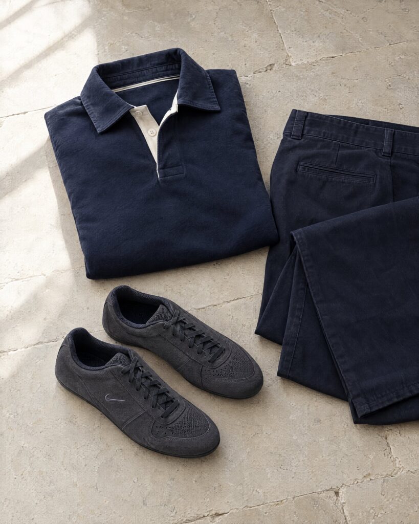 Dark suede low trainers like the Nike Air Articulate II beside a navy rugby shirt