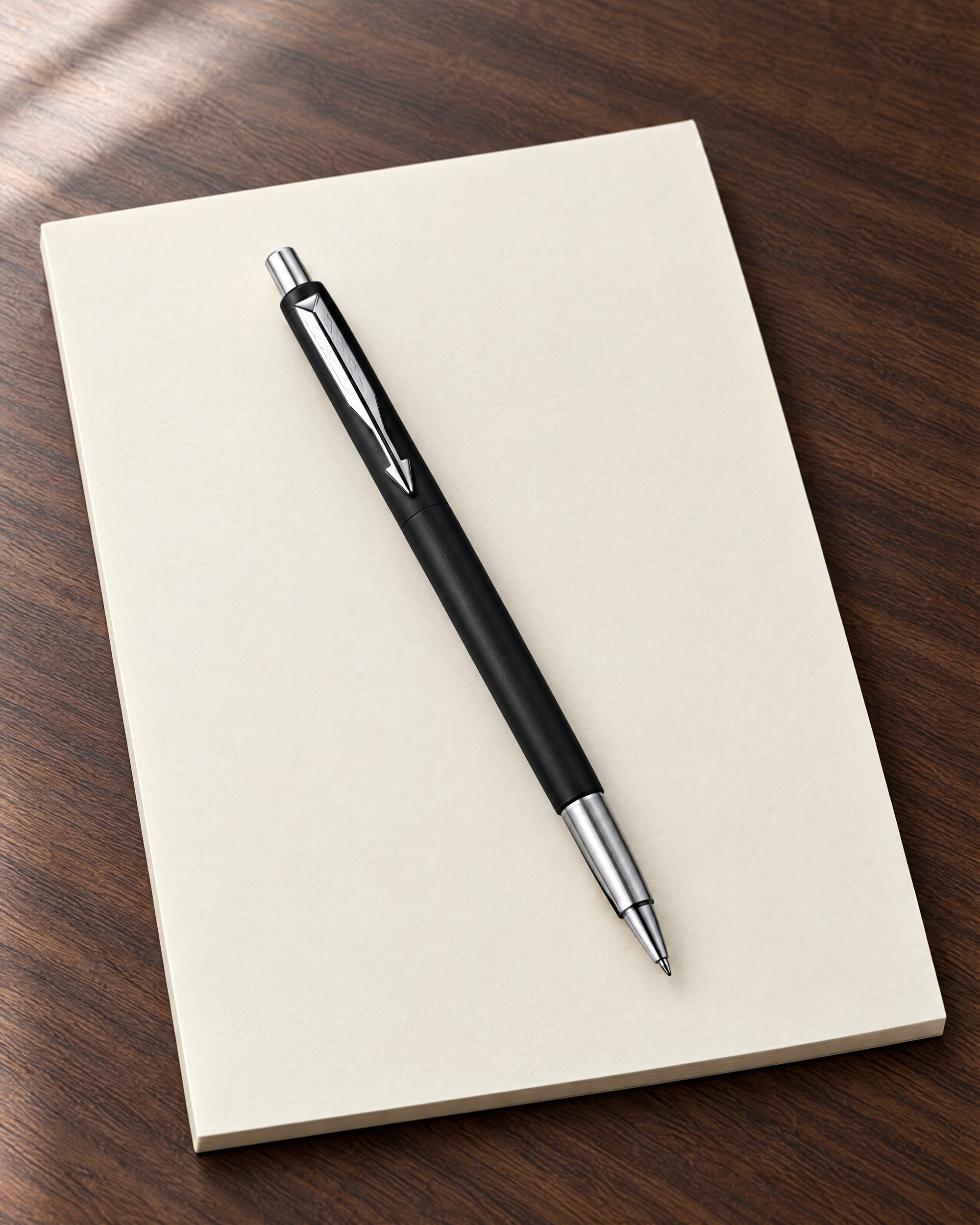 Parker Vector rollerball pen in matte black on a blank cream notepad