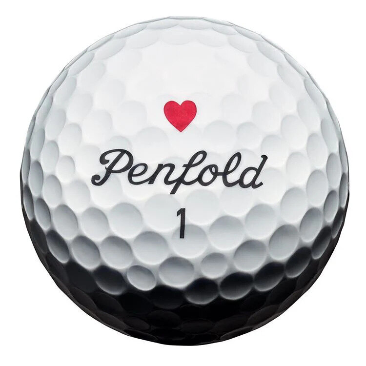 White Penfold Heart golf ball with a red heart on short grass