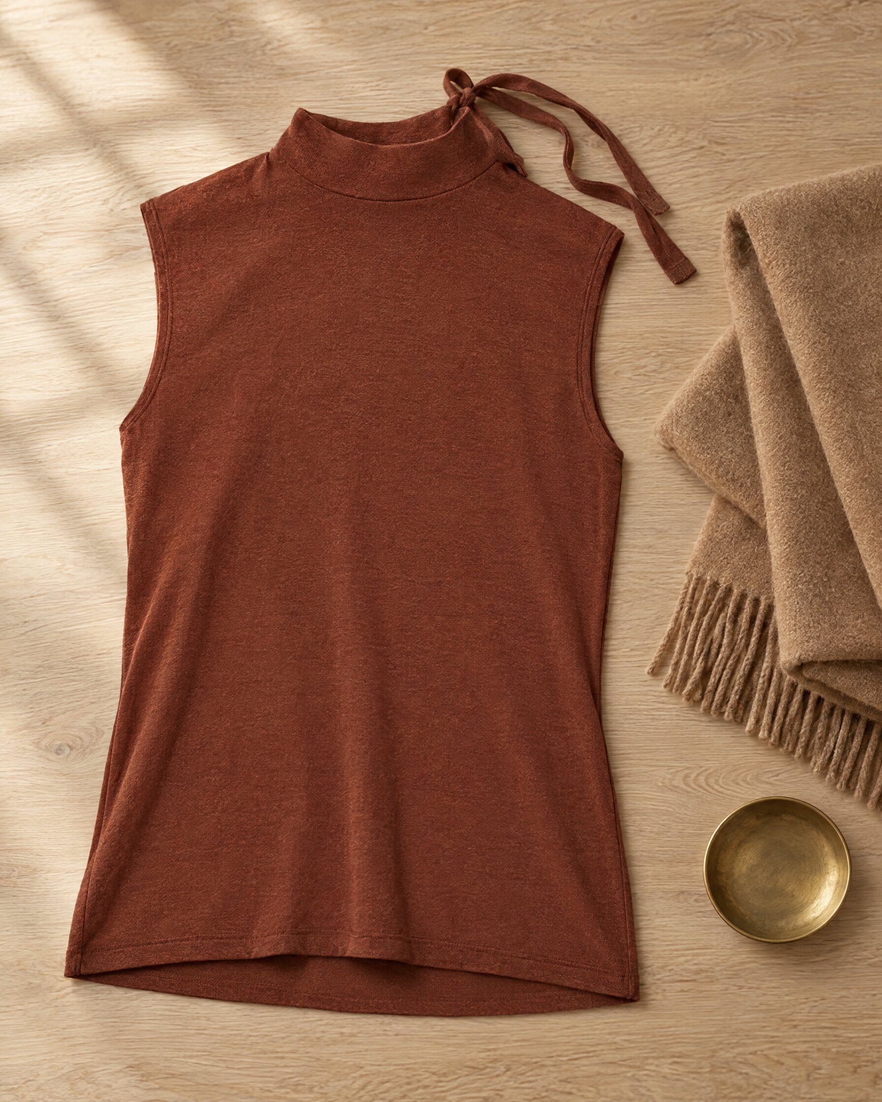 Rejina Pyo Rebecca top in chestnut jersey laid flat on an oak table with a camel scarf