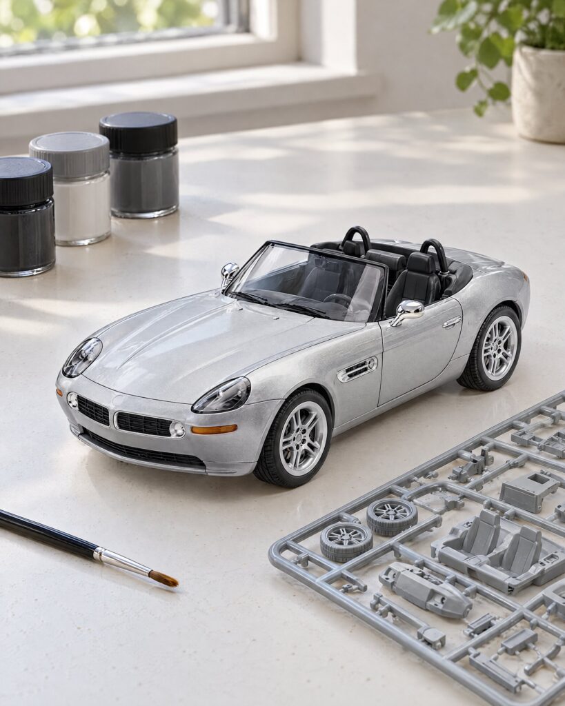 Partly built 1:24 BMW Z8 model kit on a workbench with brush and paint pots