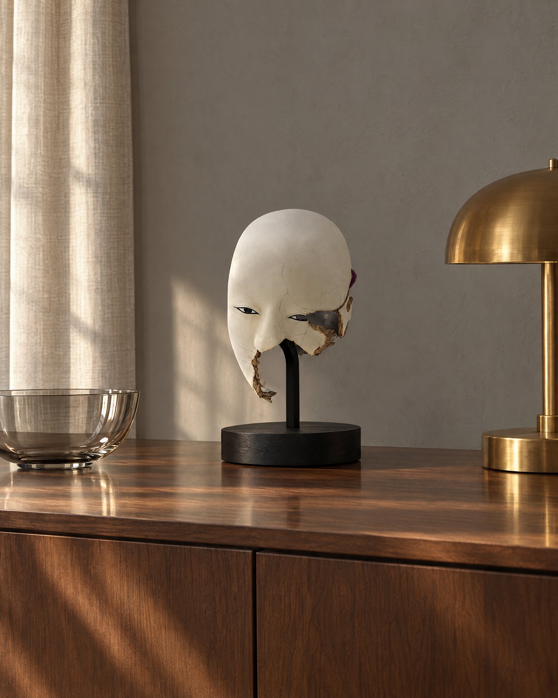Splintered Noh-style mask replica on a walnut sideboard in a quiet study