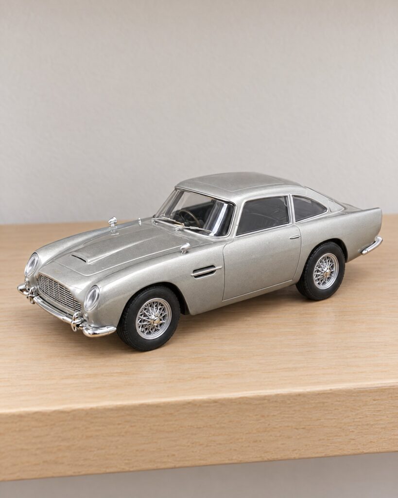 Silver 1:32 Aston Martin DB5 slot car on a wooden shelf