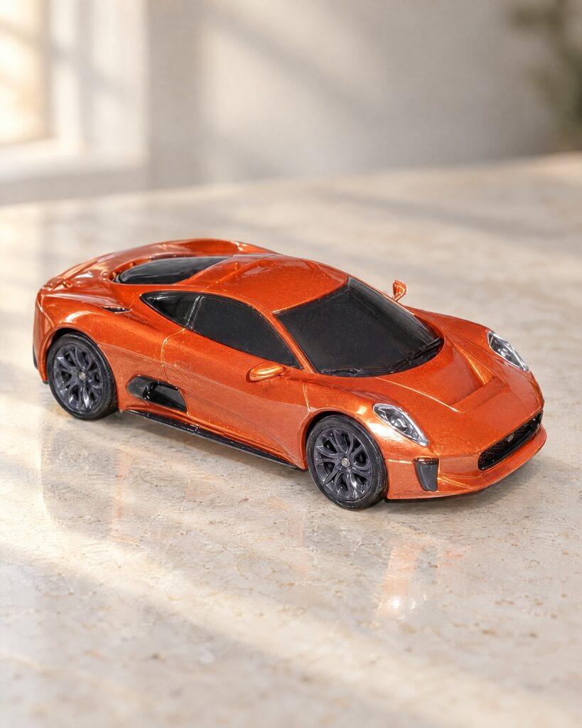 Scalextric Jaguar C-X75 slot car from the Spectre set on a pale stone surface