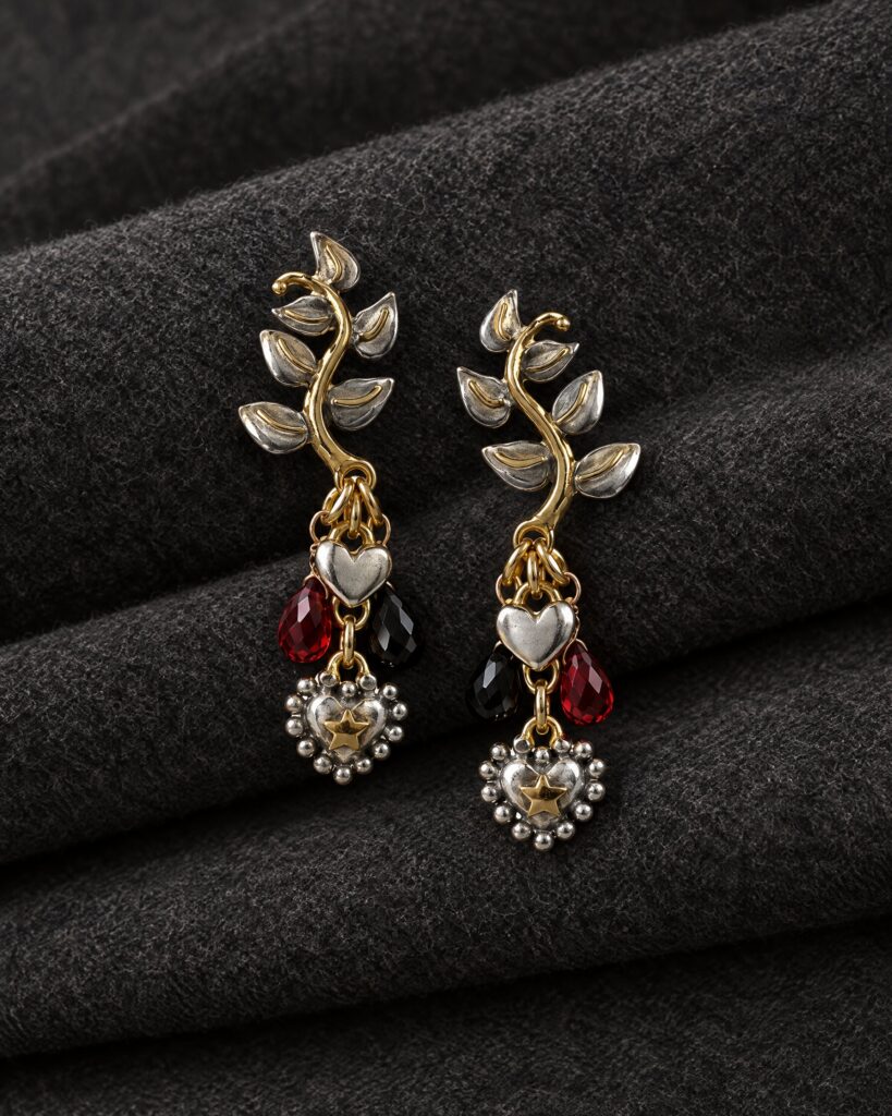 Sophie Harley Bond Leaf earrings in silver with garnet drops on grey flannel