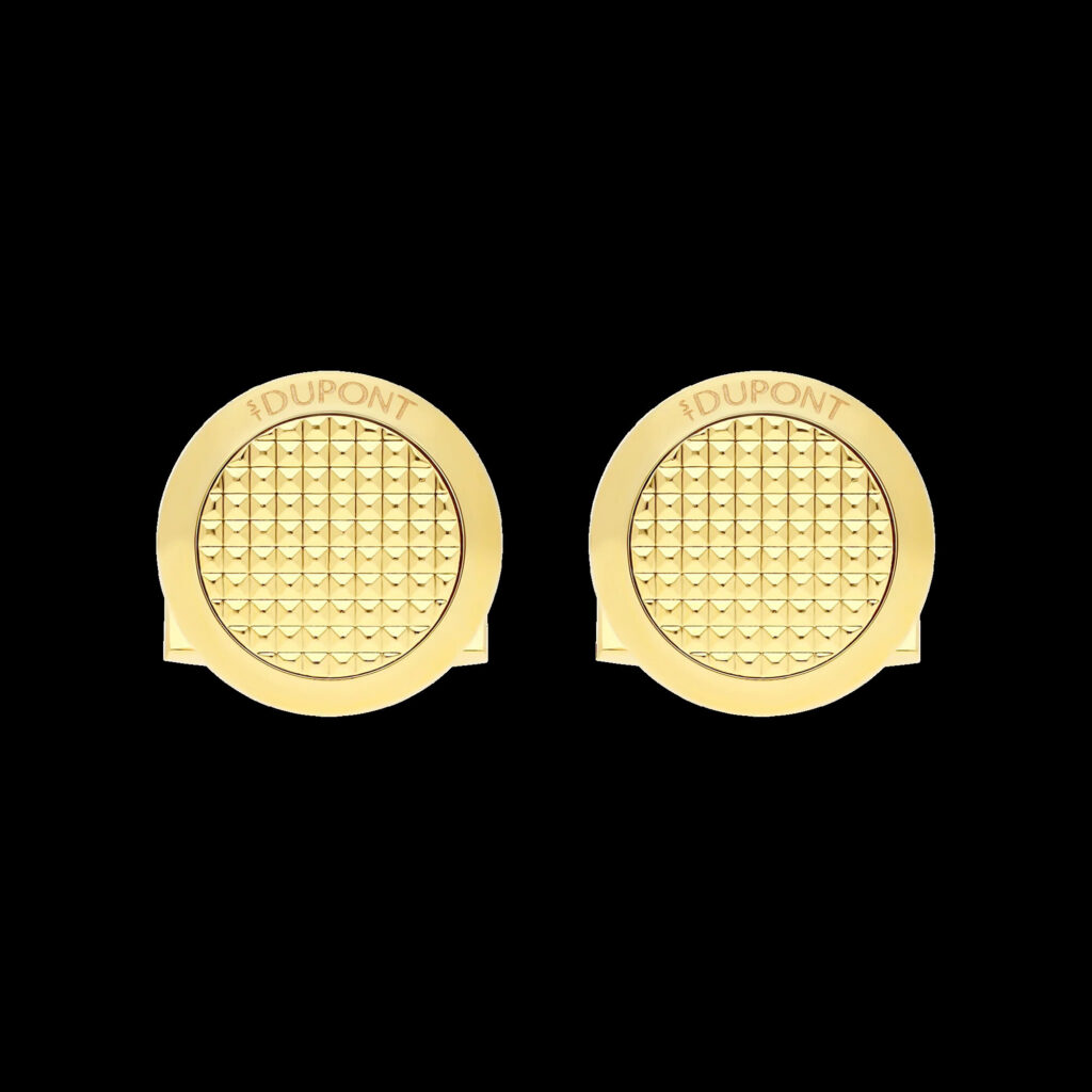 Round gold S.T. Dupont-style cufflinks with a dark grey ring on a white shirt cuff