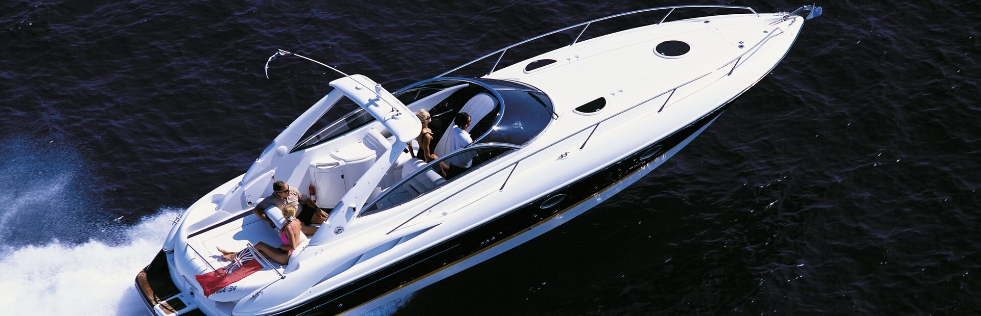 Sunseeker Superhawk 34 style white express cruiser at speed on a river