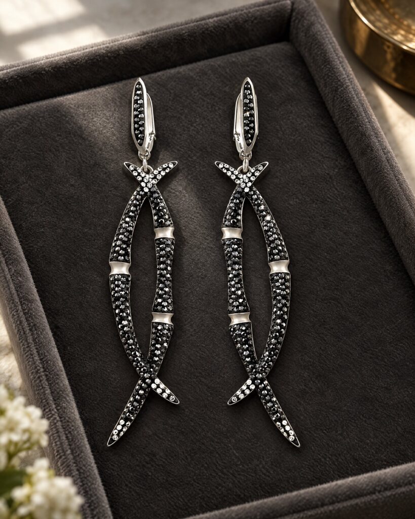 Pair of long black and clear crystal Black Bamboo drop earrings on velvet