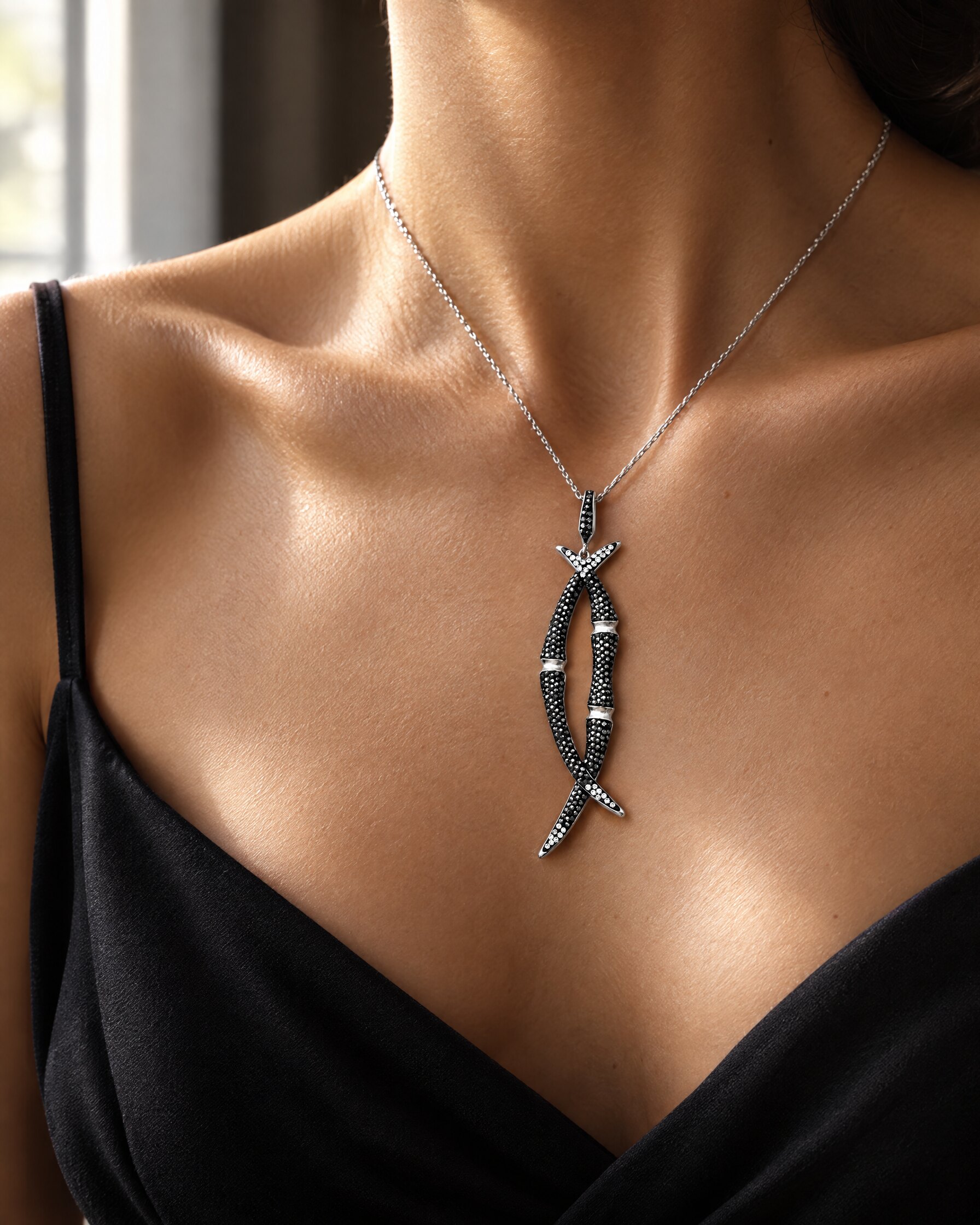 Black crystal bamboo pendant worn with a black evening dress