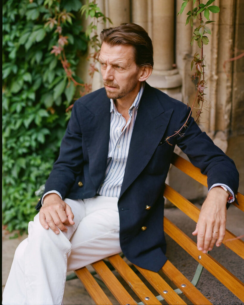 Timothy Everest Nehru jacket in midnight blue silk laid flat with a white shirt and black shoes