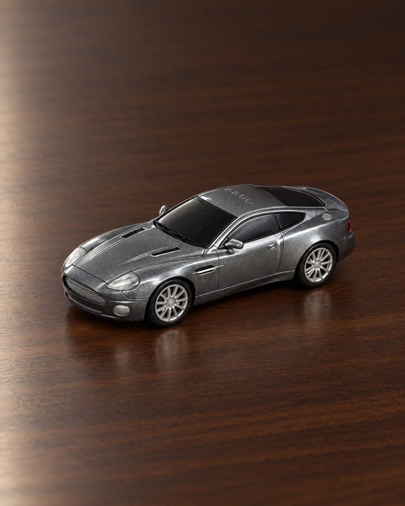 Toy State Aston Martin Vanquish style toy car on a walnut desk