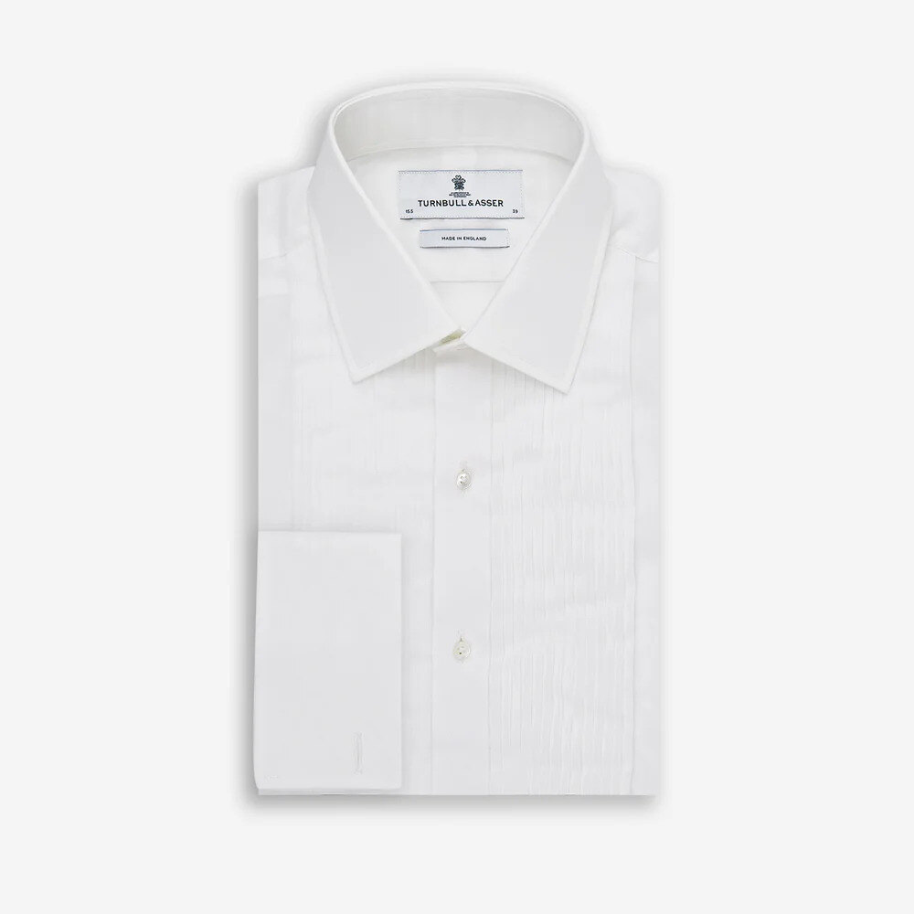 Pleated white voile dress shirt and circle-pattern silk tie flat lay