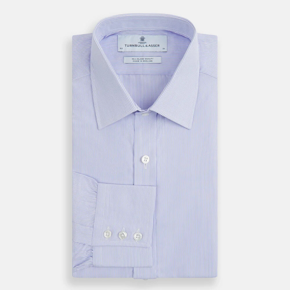 Light blue Sea Island cotton shirt folded with cufflinks and a navy tie