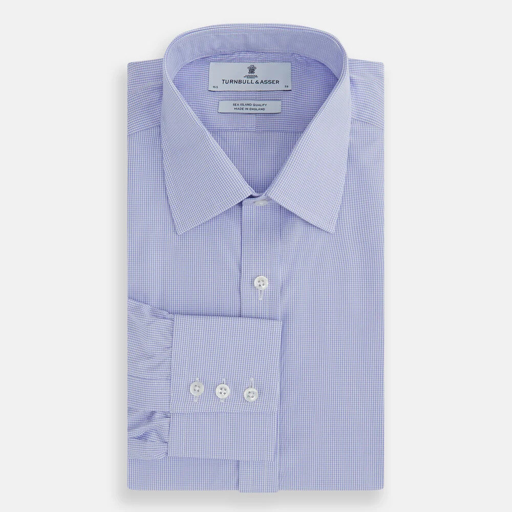 Light blue Sea Island cotton shirt folded with cufflinks and a navy tie