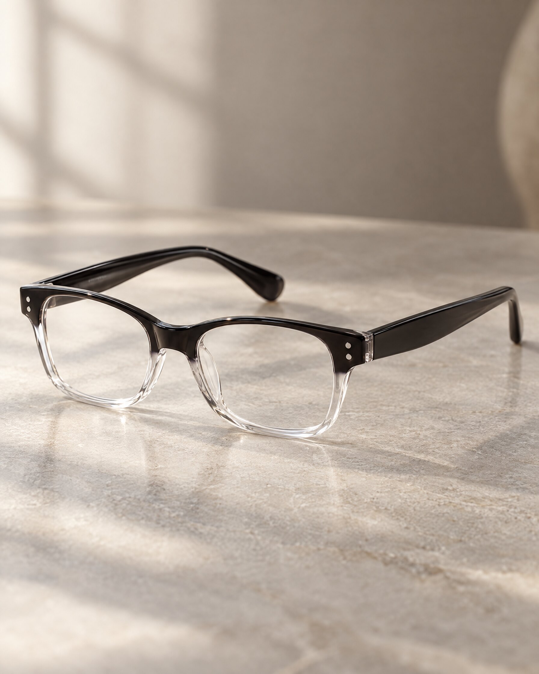 Univo U5 C1 glasses with black-to-clear gradient frame on a grey stone surface