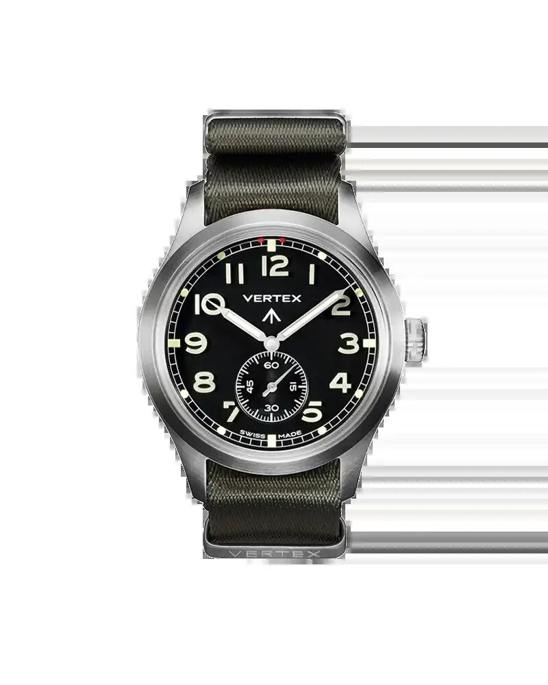 Military-style field watch on olive canvas with a brass paperweight